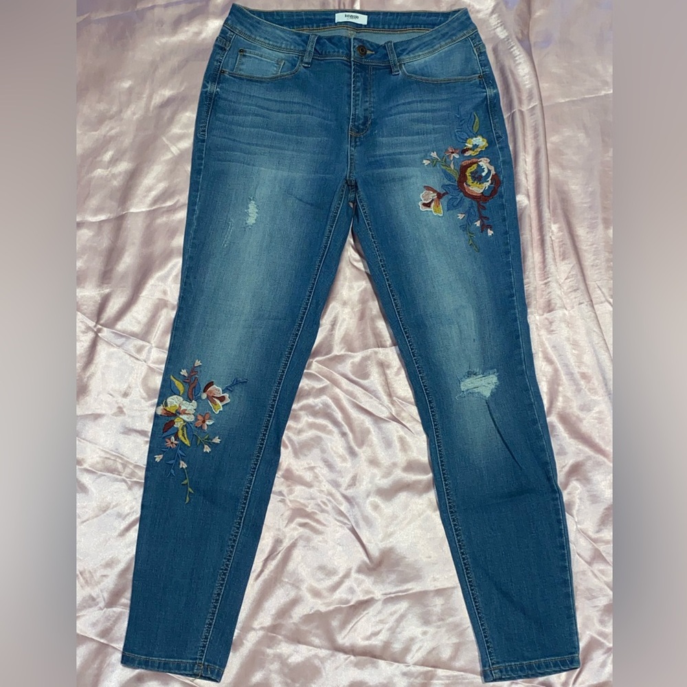Dark blue jeans with flower pattern.
